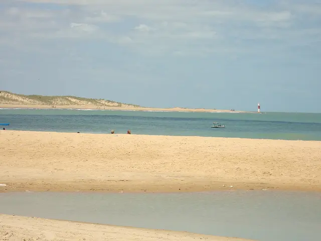 Galinhos beach and lighthouse across the channel