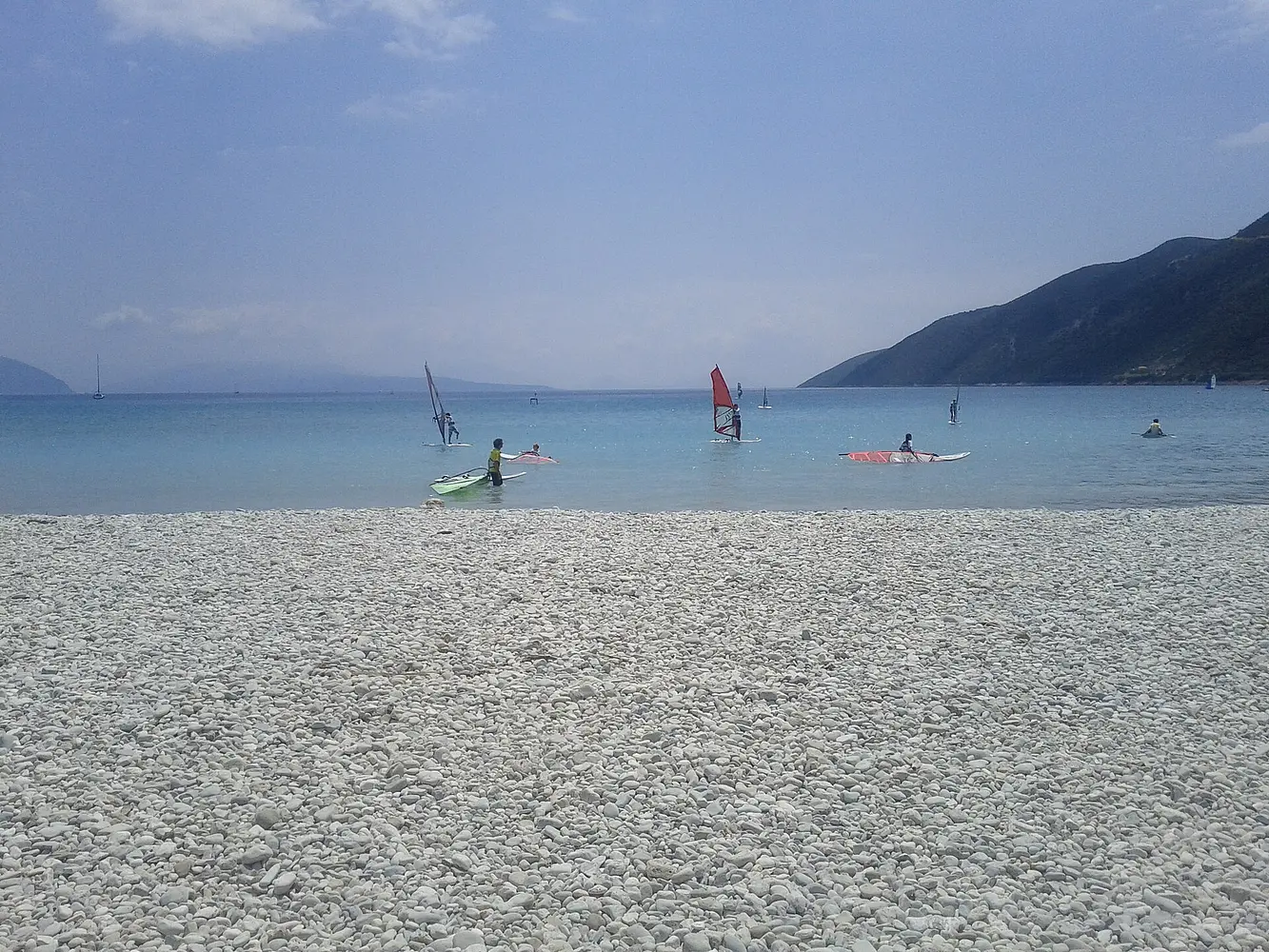 Windsurfers off the pebble beach at Vasiliki